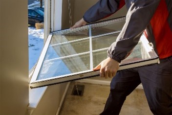 A person holding a window