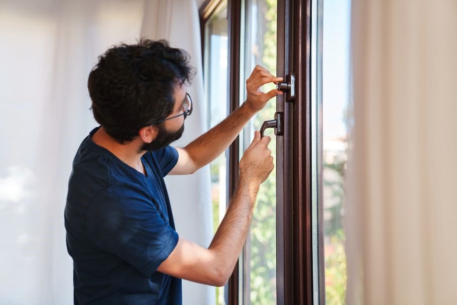 A person opening a window